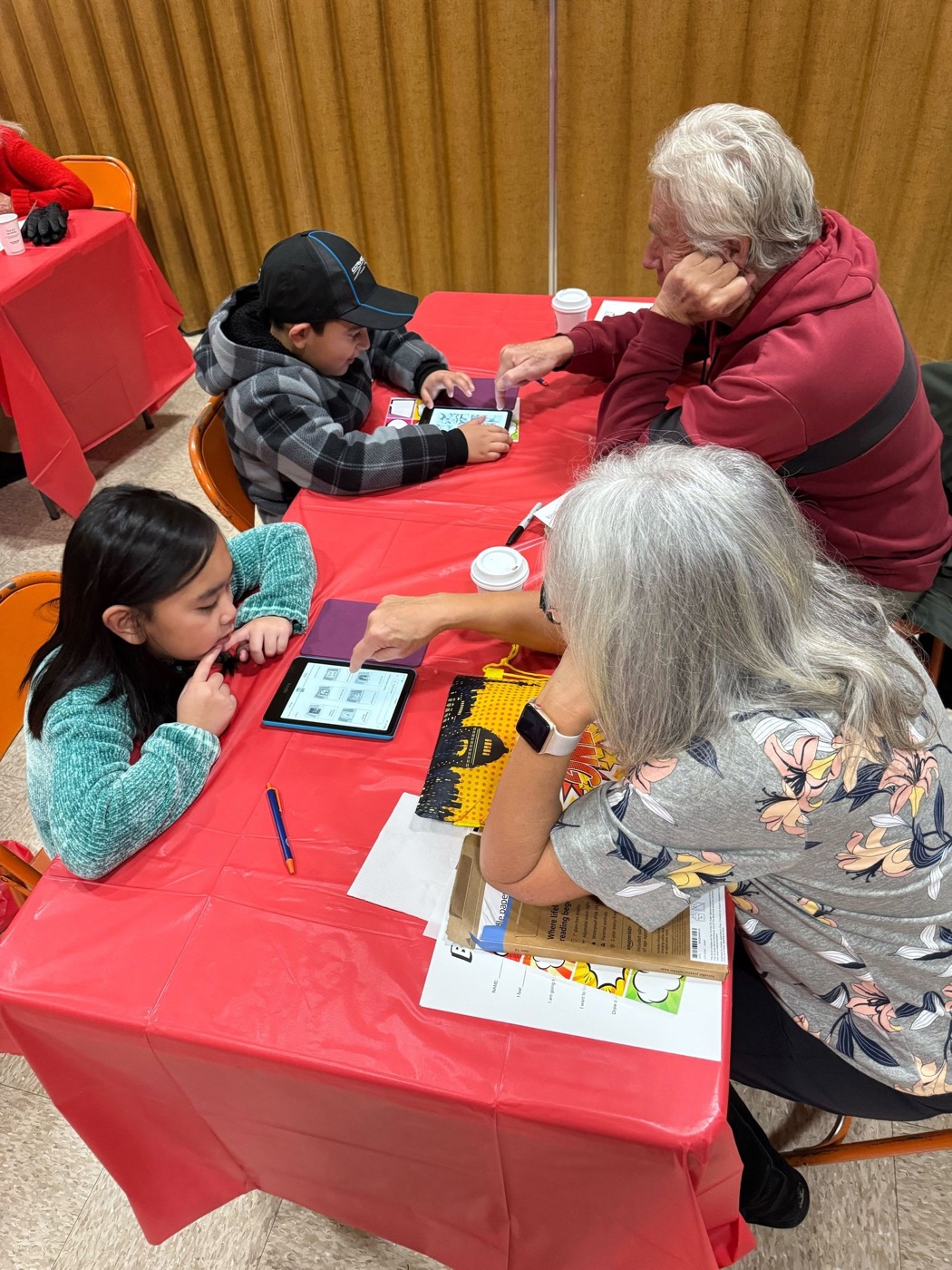 A volunteer helping a student set up her new Kindle